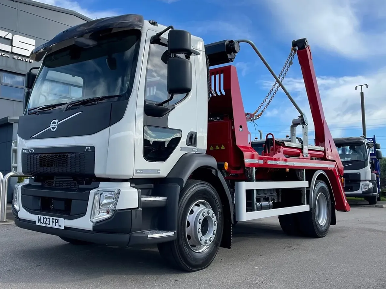 Skip lorry on road