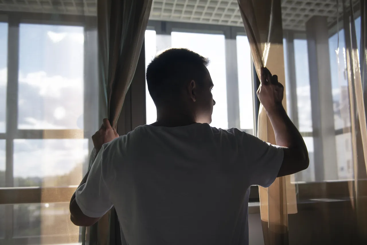 Man With Curtains Shadows From Window