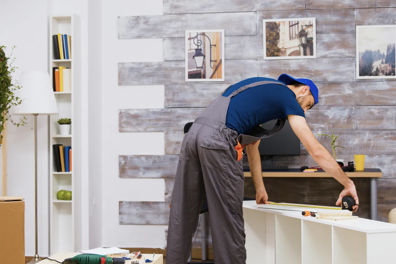 Guy Building Flatpack Shelving Unit