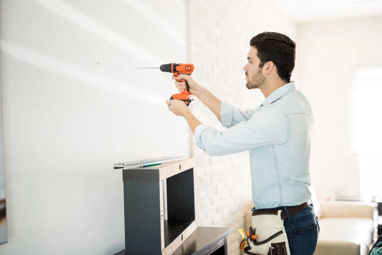 Handyman Drilling Hole In Wall