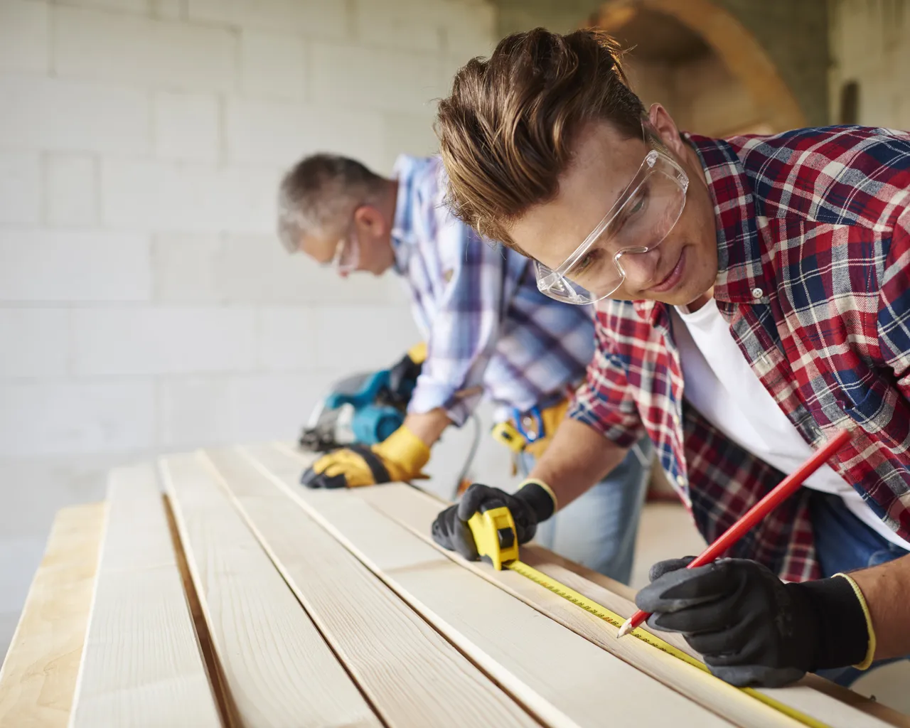 Carpenters Measuring Timber